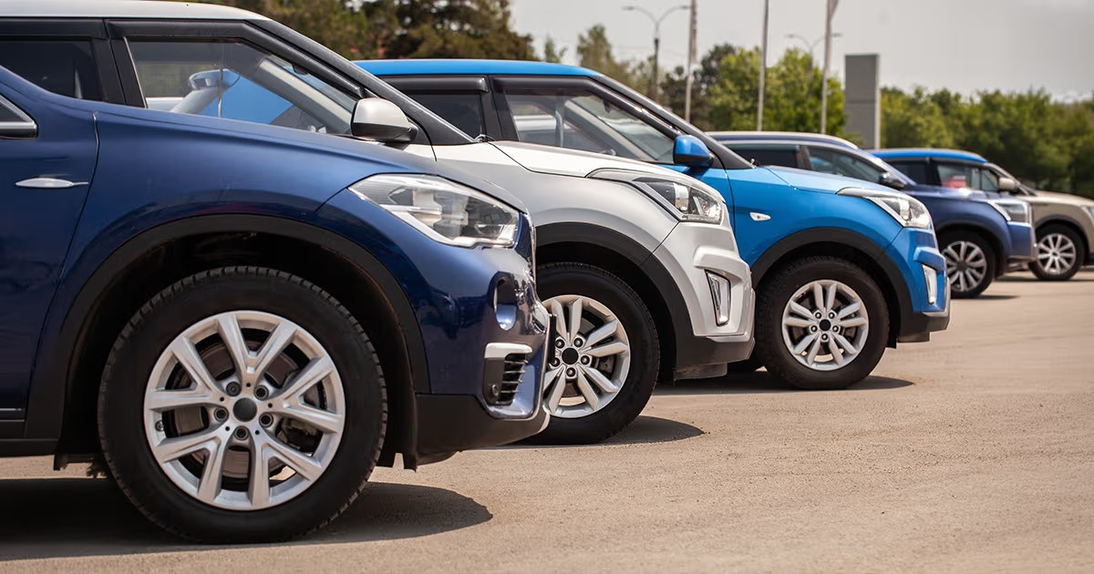 Fila de autos azules y blancos estacionados